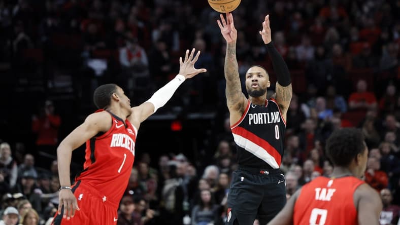 Feb 26, 2023; Portland, Oregon, USA; Portland Trail Blazers point guard Damian Lillard (0) shoots the ball over Houston Rockets power forward Jabari Smith Jr. (1) during the second half at Moda Center. Mandatory Credit: Soobum Im-USA TODAY Sports