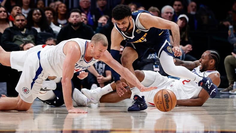 Feb 26, 2023; Denver, Colorado, USA; Los Angeles Clippers center Mason Plumlee (44) dives for the ball ahead of Denver Nuggets guard Jamal Murray (27) as forward Kawhi Leonard (2) reacts from the floor in the fourth quarter at Ball Arena. Mandatory Credit: Isaiah J. Downing-USA TODAY Sports