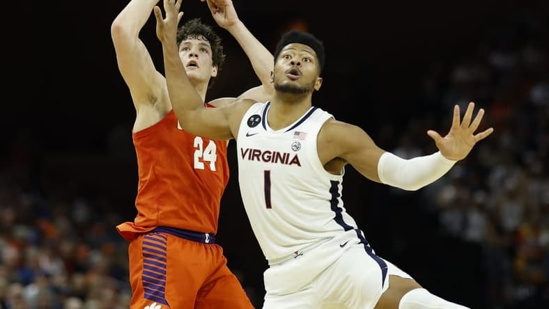 Feb 28, 2023; Charlottesville, Virginia, USA; Clemson Tigers center PJ Hall (24) and Virginia Cavaliers forward Jayden Gardner (1) follow Hall's shot in the first half at John Paul Jones Arena. Mandatory Credit: Geoff Burke-USA TODAY Sports