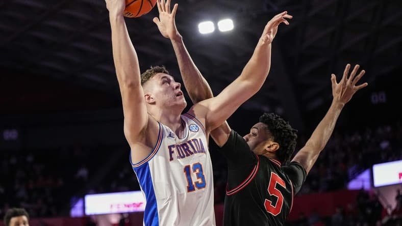 Feb 28, 2023; Athens, Georgia, USA; Florida Gators forward Aleks Szymczyk (13) shoots over Georgia Bulldogs center Frank Anselem (5) during the first half at Stegeman Coliseum. Mandatory Credit: Dale Zanine-USA TODAY Sports