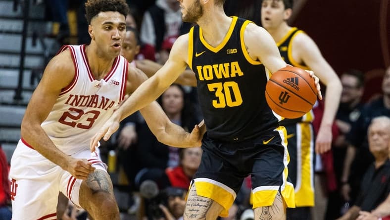 Feb 28, 2023; Bloomington, Indiana, USA; Iowa Hawkeyes guard Connor McCaffery (30) dribbles the ball while Indiana Hoosiers forward Trayce Jackson-Davis (23) defends in the first half at Simon Skjodt Assembly Hall. Mandatory Credit: Trevor Ruszkowski-USA TODAY Sports
