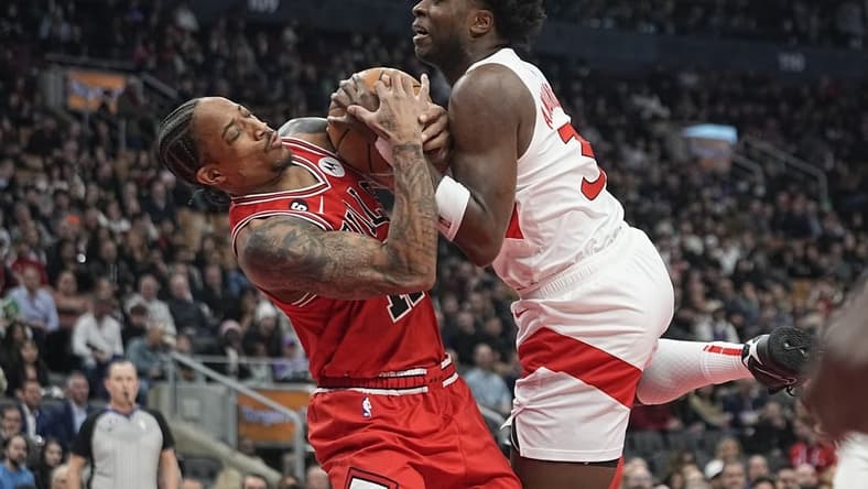 Feb 28, 2023; Toronto, Ontario, CAN; Chicago Bulls forward DeMar DeRozan (11) and Toronto Raptors forward O.G. Anunoby (3) battle for the ball during the first half at Scotiabank Arena. Mandatory Credit: John E. Sokolowski-USA TODAY Sports
