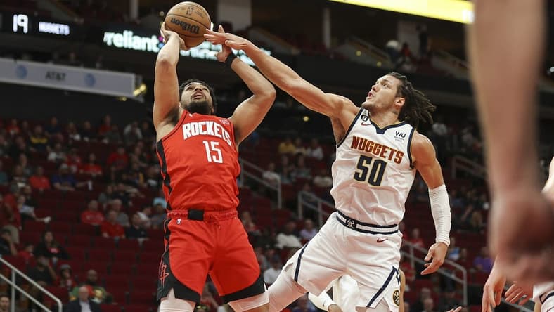 Feb 28, 2023; Houston, Texas, USA; Houston Rockets guard Daishen Nix (15) shoots the ball as Denver Nuggets forward Aaron Gordon (50) defends during the first quarter at Toyota Center. Mandatory Credit: Troy Taormina-USA TODAY Sports