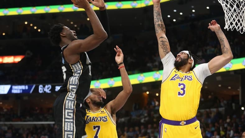 Feb 28, 2023; Memphis, Tennessee, USA; Memphis Grizzlies forward Jaren Jackson Jr. (13) shoots as Los Angeles Lakers forward Anthony Davis (3) defends during the first half at FedExForum. Mandatory Credit: Petre Thomas-USA TODAY Sports