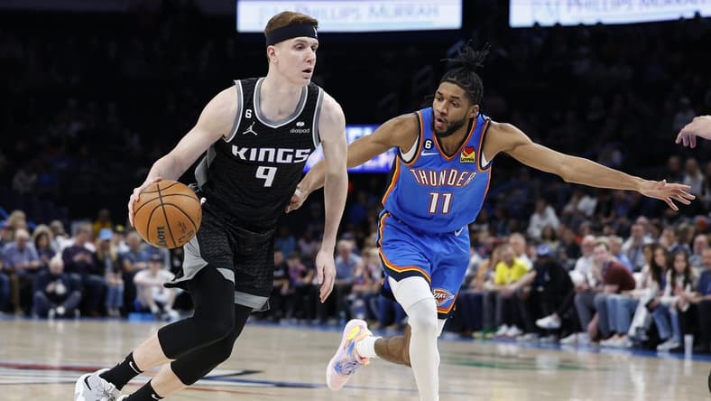 Feb 28, 2023; Oklahoma City, Oklahoma, USA; Sacramento Kings guard Kevin Huerter (9) drives to the basket around Oklahoma City Thunder guard Isaiah Joe (11) during the first quarter at Paycom Center. Mandatory Credit: Alonzo Adams-USA TODAY Sports