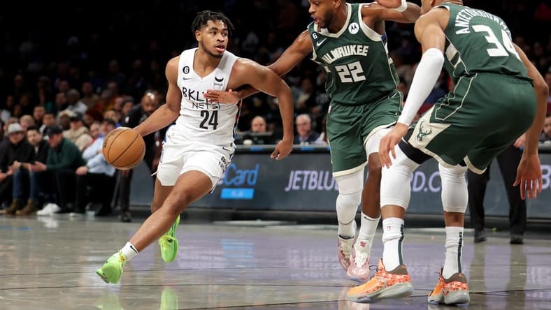 Feb 28, 2023; Brooklyn, New York, USA; Brooklyn Nets guard Cam Thomas (24) controls the ball against Milwaukee Bucks forward Khris Middleton (22) and forward Giannis Antetokounmpo (34) during the first quarter at Barclays Center. Mandatory Credit: Brad Penner-USA TODAY Sports