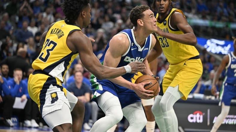 Feb 28, 2023; Dallas, Texas, USA; Dallas Mavericks center Dwight Powell (7) grabs a rebound between Indiana Pacers forward Aaron Nesmith (23) and center Myles Turner (33) during the first quarter at the American Airlines Center. Mandatory Credit: Jerome Miron-USA TODAY Sports
