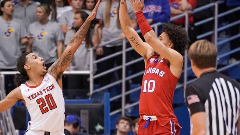 Feb 28, 2023; Lawrence, Kansas, USA; Kansas Jayhawks forward Jalen Wilson (10) shoots as Texas Tech Red Raiders guard Jaylon Tyson (20) defends during the first half at Allen Fieldhouse. Mandatory Credit: Denny Medley-USA TODAY Sports