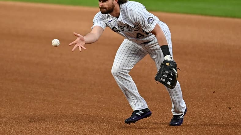 Aug 28, 2020; Denver, Colorado, USA; Colorado Rockies first baseman Daniel Murphy (9) fields the ball in the first inning against the San Diego Padres at Coors Field. Mandatory Credit: Ron Chenoy-USA TODAY Sports