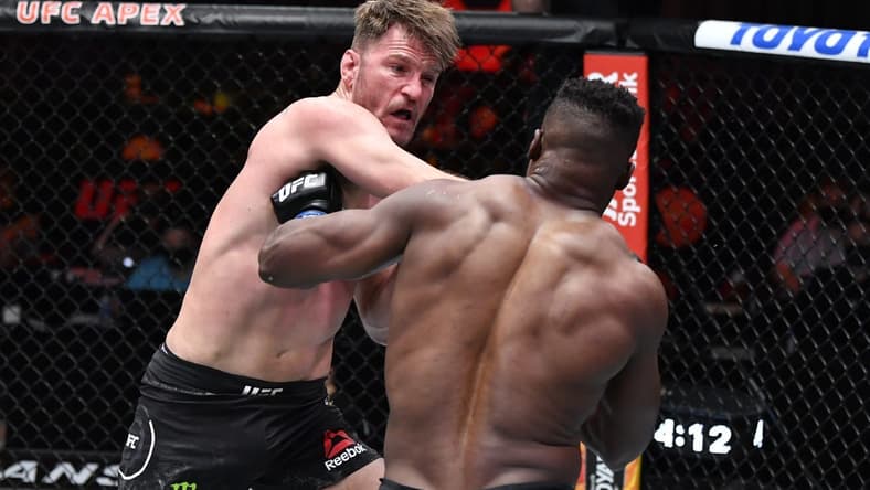 Mar 27, 2021; Las Vegas, NV, USA; Stipe Miocic punches Francis Ngannou of Cameroon in their UFC heavyweight championship fight during the UFC 260 event at UFC APEX on March 27, 2021 in Las Vegas, Nevada. Mandatory Credit: Jeff Bottari/Handout Photo via USA TODAY Sports