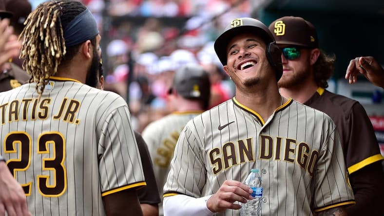 Sep 19, 2021; St. Louis, Missouri, USA; San Diego Padres third baseman Manny Machado (13) jokes around with center fielder Fernando Tatis Jr. (23) after scoring from first base during the eighth inning against the St. Louis Cardinals at Busch Stadium. Mandatory Credit: Jeff Curry-USA TODAY Sports
