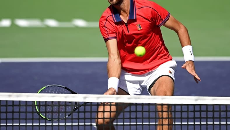 Oct 12, 2021; Indian Wells, CA, USA; Karen Khachanov (RUS) hits a shot against Pablo Carreno Busta (ESP) during a fourth round match in the BNP Paribas Open at the Indian Wells Tennis Garden. Mandatory Credit: Jayne Kamin-Oncea-USA TODAY Sports