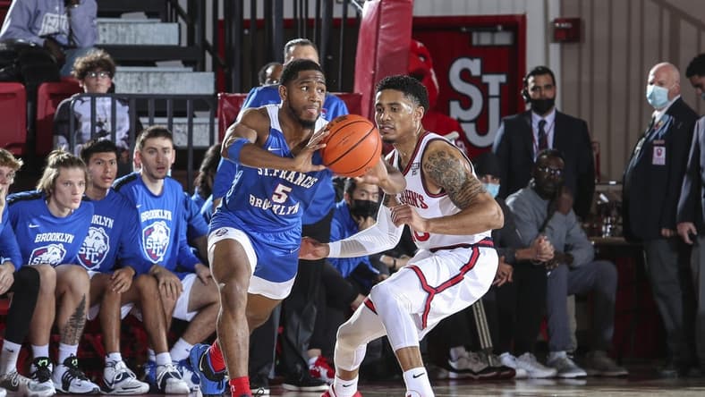 Nov 23, 2021; Queens, New York, USA; St. Francis Terriers guard Larry Moreno (5) looks to make a pass as he is guarded by St. John s Red Storm guard Tareq Coburn (10) at Carnesecca Arena. Mandatory Credit: Wendell Cruz-USA TODAY Sports