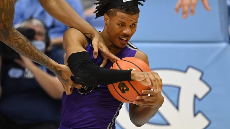 Dec 14, 2021; Chapel Hill, North Carolina, USA; Furman Paladins guard Mike Bothwell (3) with the ball as North Carolina Tar Heels forward Armando Bacot (5) defends in the second half at Dean E. Smith Center. Mandatory Credit: Bob Donnan-USA TODAY Sports