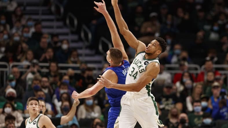 Jan 30, 2022; Milwaukee, Wisconsin, USA;  Milwaukee Bucks forward Giannis Antetokounmpo (34) and Denver Nuggets center Nikola Jokic (15) reach for the ball during the first quarter at Fiserv Forum. Mandatory Credit: Jeff Hanisch-USA TODAY Sports