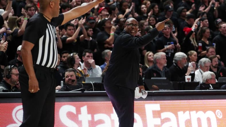 Feb 1, 2022; Lubbock, Texas, USA; Texas Tech Red Raiders assistant coach Corey Williams gives instructions in front of Big 12 official Keith Kimble during the game against the Texas Longhorns at United Supermarkets Arena. Mandatory Credit: Michael C. Johnson-USA TODAY Sports