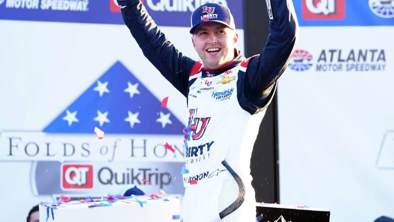 Mar 20, 2022; Hampton, Georgia, USA; NASCAR Cup Series driver William Byron (24) celebrates in victory lane winning the Folds of Honor QuikTrip 500 at Atlanta Motor Speedway. Mandatory Credit: John David Mercer-USA TODAY Sports