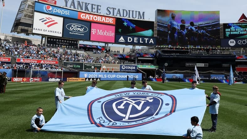 May 1, 2022; New York, New York, USA; Young fans hold a New York City FC banner on the pitch before the game against the San Jose Earthquakes at Yankee Stadium. Mandatory Credit: Vincent Carchietta-USA TODAY Sports