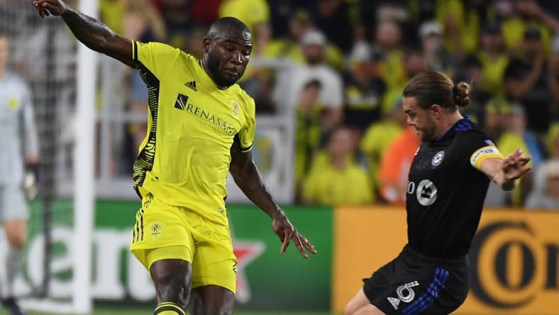 May 18, 2022; Nashville, Tennessee, USA; Nashville SC midfielder Brian Anunga (27) against CF Montreal midfielder Samuel Piette (6) during the second half at GEODIS Park. Mandatory Credit: Christopher Hanewinckel-USA TODAY Sports