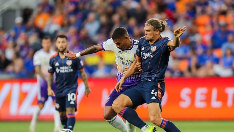 Jun 24, 2022; Cincinnati, Ohio, USA; Orlando City SC midfielder Junior Urso (11) battles for the ball against FC Cincinnati defender Nick Hagglund (4) in the second half at TQL Stadium. Mandatory Credit: Katie Stratman-USA TODAY Sports