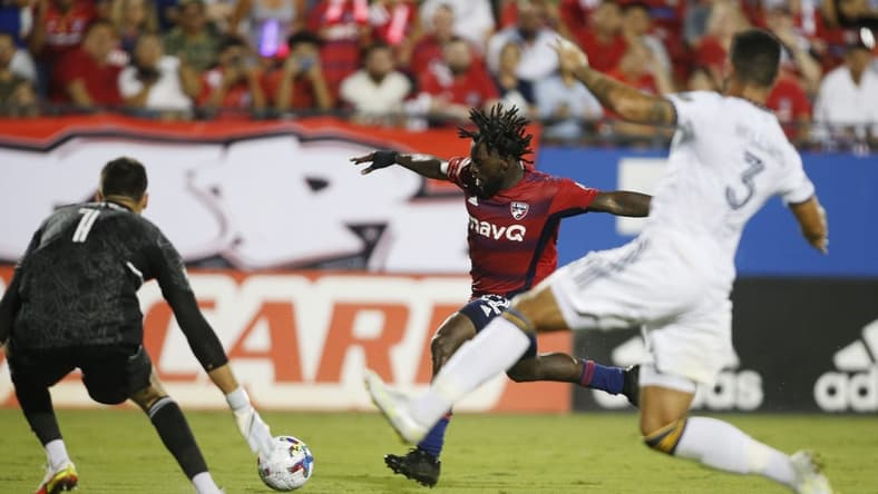Jul 30, 2022; Frisco, Texas, USA; FC Dallas midfielder Ema Twumasi (22) shoots the ball against Los Angeles Galaxy goalkeeper Jonathan Bond (1) in the second half at Toyota Stadium. Mandatory Credit: Tim Heitman-USA TODAY Sports