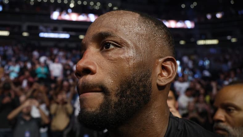 Aug 20, 2022; Salt Lake City, Utah, USA; Leon Edwards (blue gloves) leaves the arena after defeating Kamaru Usman (red gloves) during UFC 278 at Vivint Arena. Mandatory Credit: Jeffrey Swinger-USA TODAY Sports