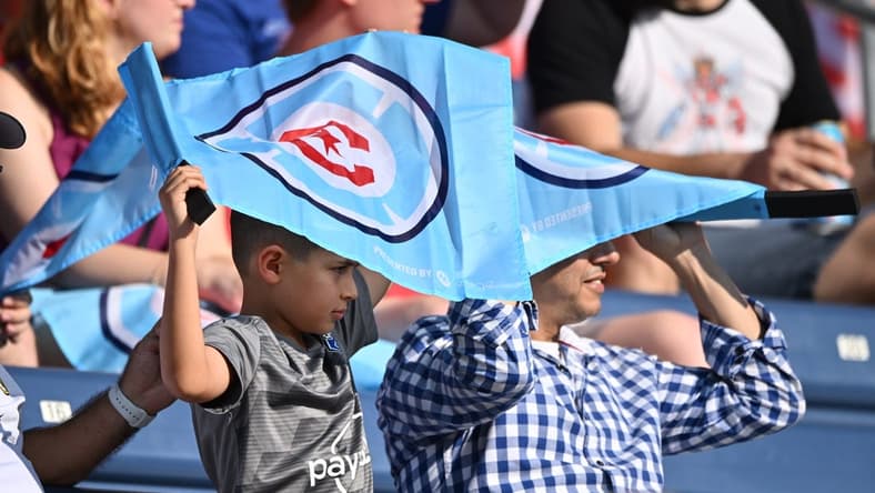 Aug 21, 2022; Chicago, Illinois, USA;  Fans shield themselves from the sun using their Chicago Fire FC flags during the first half of a game against New York City FC at Bridgeview Stadium. Mandatory Credit: Jamie Sabau-USA TODAY Sports