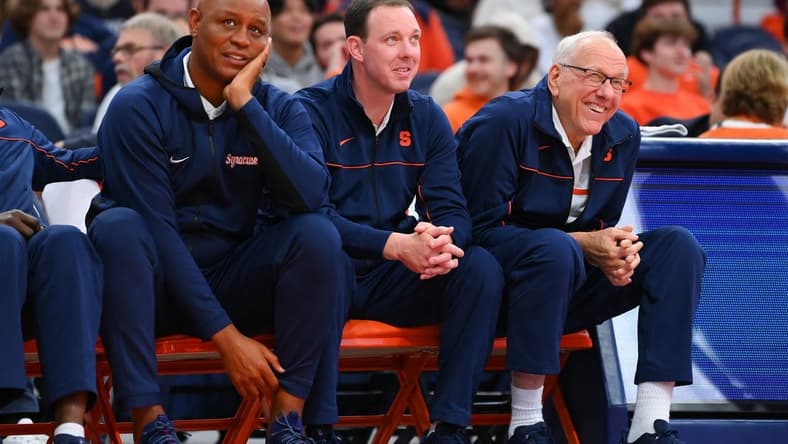 Oct 14, 2022; Syracuse, New York, US; Syracuse Orange associate head coach Adrian Autry (left) and assistant coach Gerry McNamara (center) and head coach Jim Boeheim (right) watch the action at the Orange Tip Off at the JMA Wireless Dome. Mandatory Credit: Rich Barnes-USA TODAY Sports