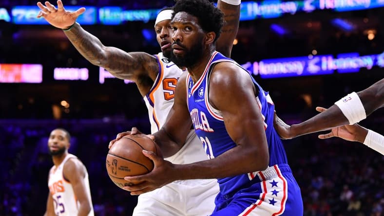 Nov 7, 2022; Philadelphia, Pennsylvania, USA; Philadelphia 76ers center Joel Embiid (21) shields the ball from Phoenix Suns forward Torrey Craig (0) in the first quarter at Wells Fargo Center. Mandatory Credit: Kyle Ross-USA TODAY Sports