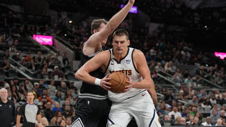 Nov 7, 2022; San Antonio, Texas, USA;  Denver Nuggets center Nikola Jokic (15) drives in against San Antonio Spurs center Jakob Poeltl (25) in the second half at the AT&T Center. Mandatory Credit: Daniel Dunn-USA TODAY Sports