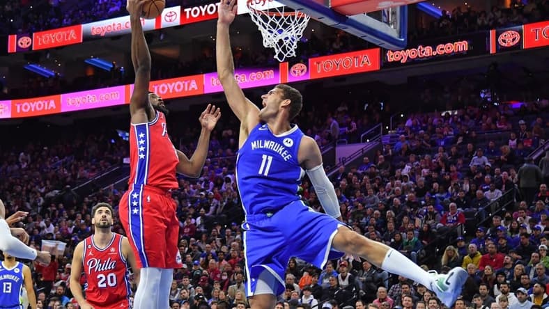 Nov 18, 2022; Philadelphia, Pennsylvania, USA; Philadelphia 76ers center Joel Embiid (21) grabs a rebound against Milwaukee Bucks center Brook Lopez (11) during the third quarter at Wells Fargo Center. Mandatory Credit: Eric Hartline-USA TODAY Sports