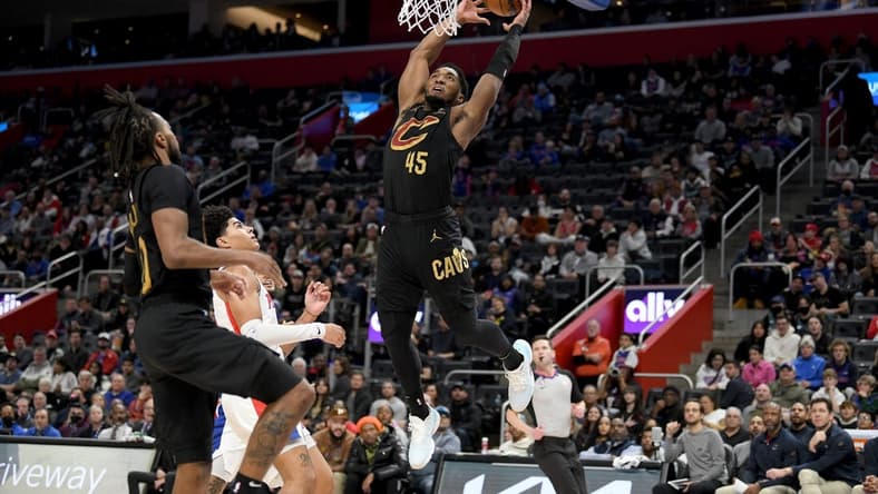 Nov 27, 2022; Detroit, Michigan, USA;  Cleveland Cavaliers guard Donovan Mitchell (45) tries to finish off an alley-oop against the Detroit Pistons in the second quarter at Little Caesars Arena. Mandatory Credit: Lon Horwedel-USA TODAY Sports