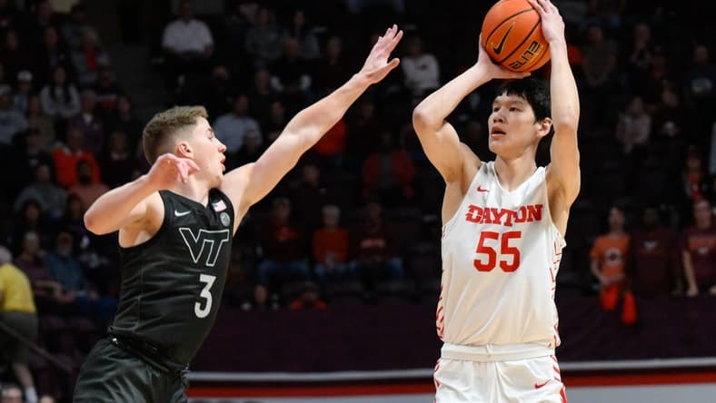 Dec 7, 2022; Blacksburg, Virginia, USA; Dayton Flyers forward Mike Sharavjamts (55) shoots over Virginia Tech Hokies guard Sean Pedulla (3) at Cassell Coliseum. Mandatory Credit: Lee Luther Jr.-USA TODAY Sports