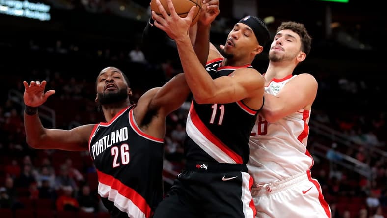 Dec 17, 2022; Houston, Texas, USA; From left, Portland Trail Blazers forward Justise Winslow (26), Portland Trail Blazers guard Josh Hart (11) and Houston Rockets center Alperen Sengun (28) battle for a rebound during the first quarter at Toyota Center. Mandatory Credit: Erik Williams-USA TODAY Sports