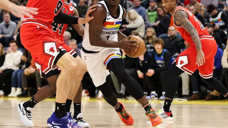 Dec 18, 2022; Minneapolis, Minnesota, USA; Minnesota Timberwolves guard Anthony Edwards (1) dribbles while Chicago Bulls center Nikola Vucevic (9) defends during the first quarter at Target Center. Mandatory Credit: Matt Krohn-USA TODAY Sports