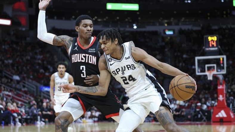 Dec 19, 2022; Houston, Texas, USA; San Antonio Spurs guard Devin Vassell (24) attempts to dribble the ball around Houston Rockets guard Kevin Porter Jr. (3) during the third quarter at Toyota Center. Mandatory Credit: Troy Taormina-USA TODAY Sports