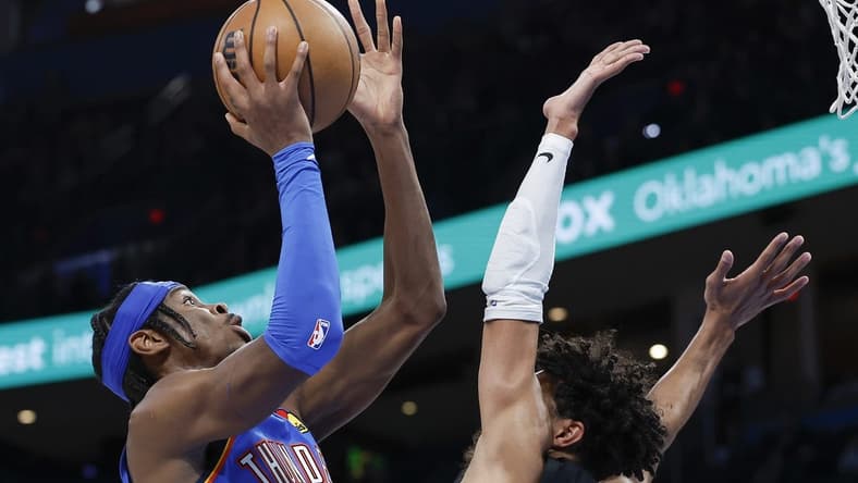 Dec 27, 2022; Oklahoma City, Oklahoma, USA; Oklahoma City Thunder guard Shai Gilgeous-Alexander (2) shoots against San Antonio Spurs guard Tre Jones (33) during the second half at Paycom Center. Oklahoma City won 130-114. Mandatory Credit: Alonzo Adams-USA TODAY Sports