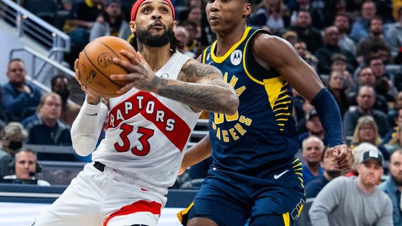 Jan 2, 2023; Indianapolis, Indiana, USA; Toronto Raptors guard Gary Trent Jr. (33) shoots the ball while Indiana Pacers guard Bennedict Mathurin (00) defends in the second half at Gainbridge Fieldhouse. Mandatory Credit: Trevor Ruszkowski-USA TODAY Sports