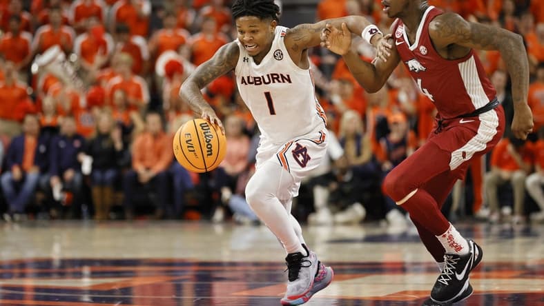 Jan 7, 2023; Auburn, Alabama, USA; Auburn Tigers guard Wendell Green Jr. (1) moves the ball against Arkansas Razorbacks guard Davonte Davis (4) during the second half at Neville Arena. Mandatory Credit: John Reed-USA TODAY Sports
