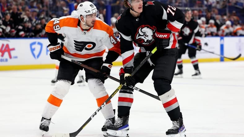 Jan 9, 2023; Buffalo, New York, USA; Philadelphia Flyers left wing Noah Cates (49) and Buffalo Sabres center Tage Thompson (72) look for the puck during the second period at KeyBank Center. Mandatory Credit: Timothy T. Ludwig-USA TODAY Sports