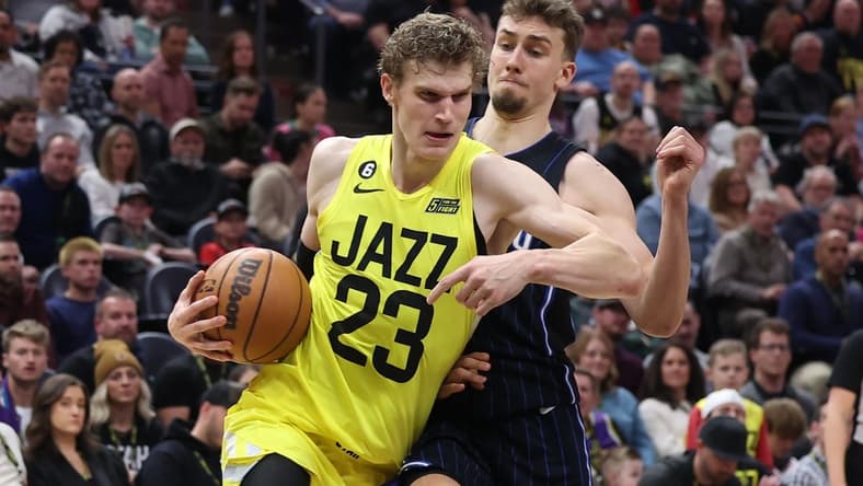 Jan 13, 2023; Salt Lake City, Utah, USA; Utah Jazz forward Lauri Markkanen (23) drives with the ball against Orlando Magic forward Franz Wagner (22) in the second half at Vivint Arena. Mandatory Credit: Rob Gray-USA TODAY Sports