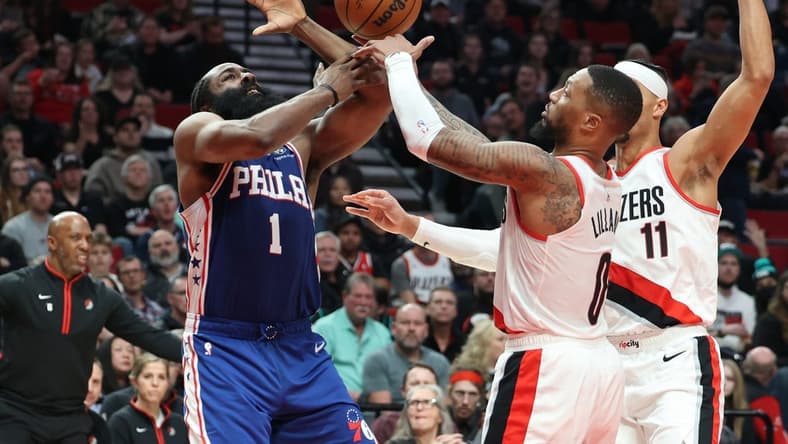 Jan 19, 2023; Portland, Oregon, USA; Philadelphia 76ers guard James Harden (1) looses the ball to Portland Trail Blazers guard Damian Lillard (0) in the second half at Moda Center. Mandatory Credit: Jaime Valdez-USA TODAY Sports