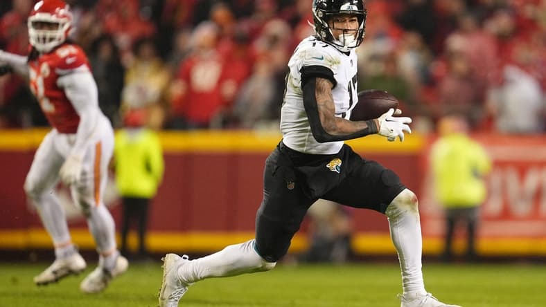 Jan 21, 2023; Kansas City, Missouri, USA; Jacksonville Jaguars tight end Evan Engram (17) runs the ball against the Kansas City Chiefs during the second half in the AFC divisional round game at GEHA Field at Arrowhead Stadium. Mandatory Credit: Jay Biggerstaff-USA TODAY Sports
