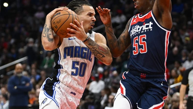 Jan 21, 2023; Washington, District of Columbia, USA; Orlando Magic guard Cole Anthony (50) drives against Washington Wizards guard Delon Wright (55) during the first half at Capital One Arena. Mandatory Credit: Brad Mills-USA TODAY Sports