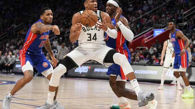 Jan 23, 2023; Detroit, Michigan, USA; Milwaukee Bucks forward Giannis Antetokounmpo's (34) drives to the basket against Detroit Pistons guard Rodney McGruder (17) (left) and center Jalen Duran (0) in the third quarter at Little Caesars Arena. Mandatory Credit: Lon Horwedel-USA TODAY Sports