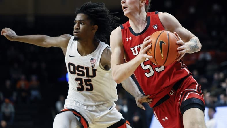 Jan 26, 2023; Corvallis, Oregon, USA; Utah Utes guard Gabe Madsen (55, right) drives to the basket against Oregon State Beavers forward Glenn Taylor Jr. (35) during the second half at Gill Coliseum. Mandatory Credit: Soobum Im-USA TODAY Sports