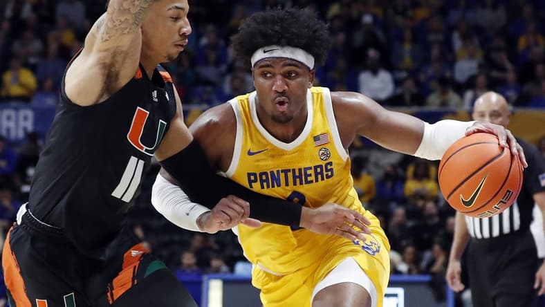 Jan 28, 2023; Pittsburgh, Pennsylvania, USA; Pittsburgh Panthers forward Blake Hinson (right) drives to the basket against Miami (Fl) Hurricanes guard Jordan Miller (11) during the first half at the Petersen Events Center. Mandatory Credit: Charles LeClaire-USA TODAY Sports