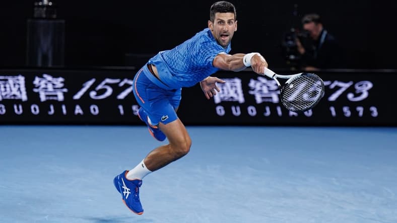 Jan 29, 2023; Melbourne, Victoria, Australia; Novak Djokovic of Serbia hits a shot against Stefanos Tsitsipas of Greece at the men's final on day fourteen of the 2023 Australian Open tennis tournament at Melbourne Park. Mandatory Credit: Mike Frey-USA TODAY Sports