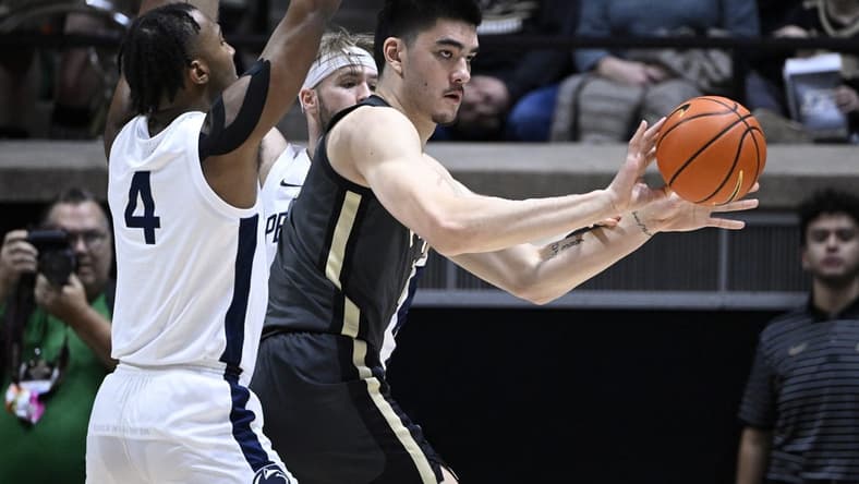 Feb 1, 2023; West Lafayette, Indiana, USA;  Purdue Boilermakers center Zach Edey (15) passes the ball away from Penn State Nittany Lions forward Caleb Dorsey (4) and forward Michael Henn (24) during the first half at Mackey Arena. Mandatory Credit: Marc Lebryk-USA TODAY Sports