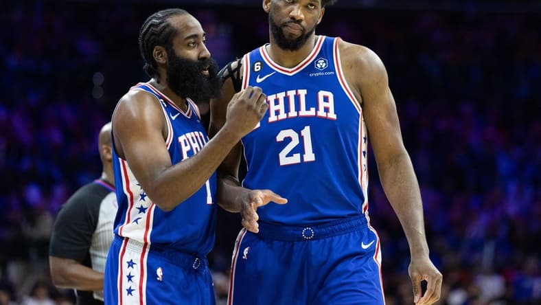 Feb 1, 2023; Philadelphia, Pennsylvania, USA; Philadelphia 76ers guard James Harden (1) and center Joel Embiid (21) talks during a break in the fourth quarter against the Orlando Magic at Wells Fargo Center. Mandatory Credit: Bill Streicher-USA TODAY Sports